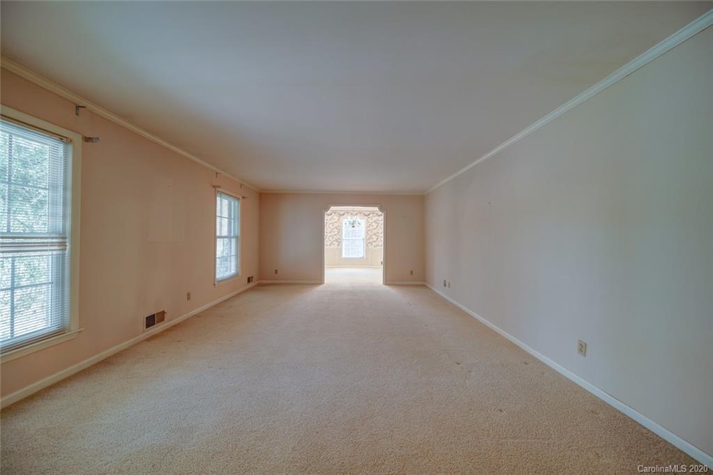 1415 Melchor Road Albemarle, NC 28001 - Photo 32 of 47 a view of a big room with windows and chandelier fan