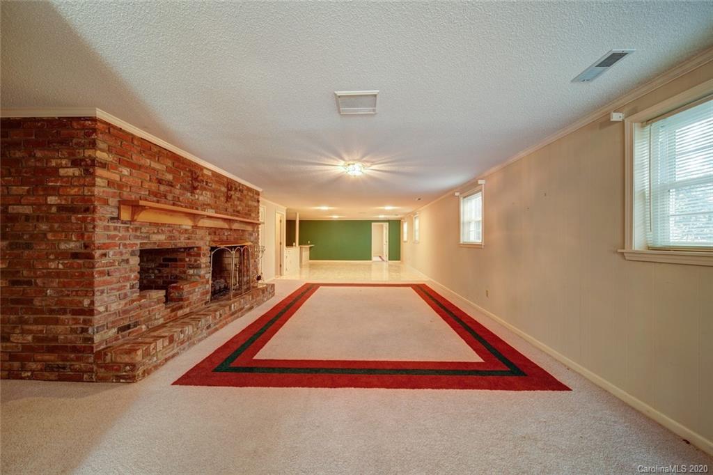 1415 Melchor Road Albemarle, NC 28001 - Photo 35 of 47 a living room with a fireplace and windows
