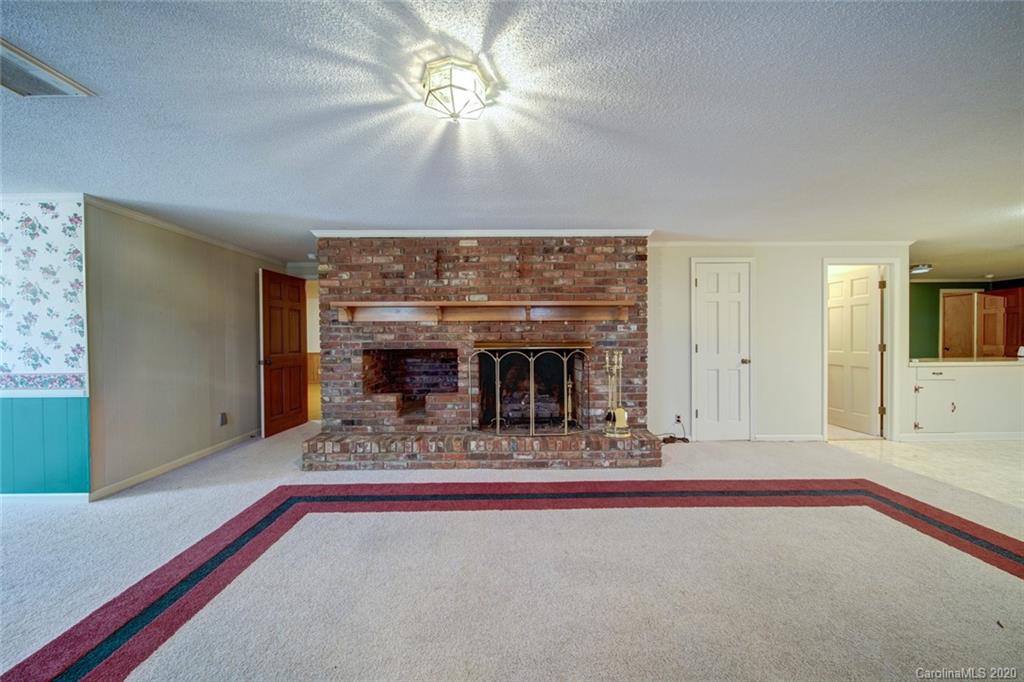 1415 Melchor Road Albemarle, NC 28001 - Photo 39 of 47 a living room with fireplace furniture and a chandelier