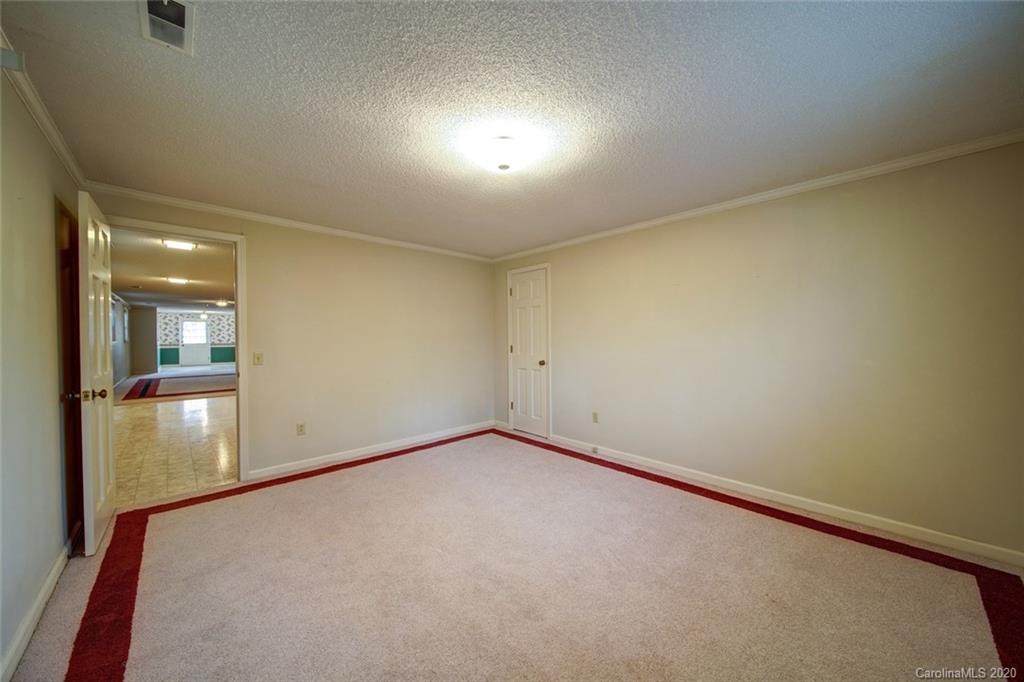 1415 Melchor Road Albemarle, NC 28001 - Photo 41 of 47 an empty room with mirror and a wooden floor