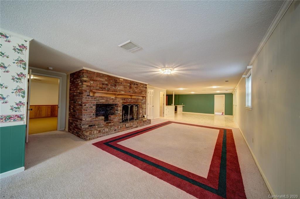 1415 Melchor Road Albemarle, NC 28001 - Photo 42 of 47 a view of an empty room with a fireplace and a window