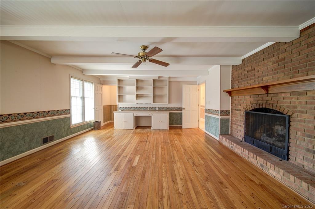 1415 Melchor Road Albemarle, NC 28001 - Photo 8 of 47 a view of a livingroom with wooden floor a fireplace and windows