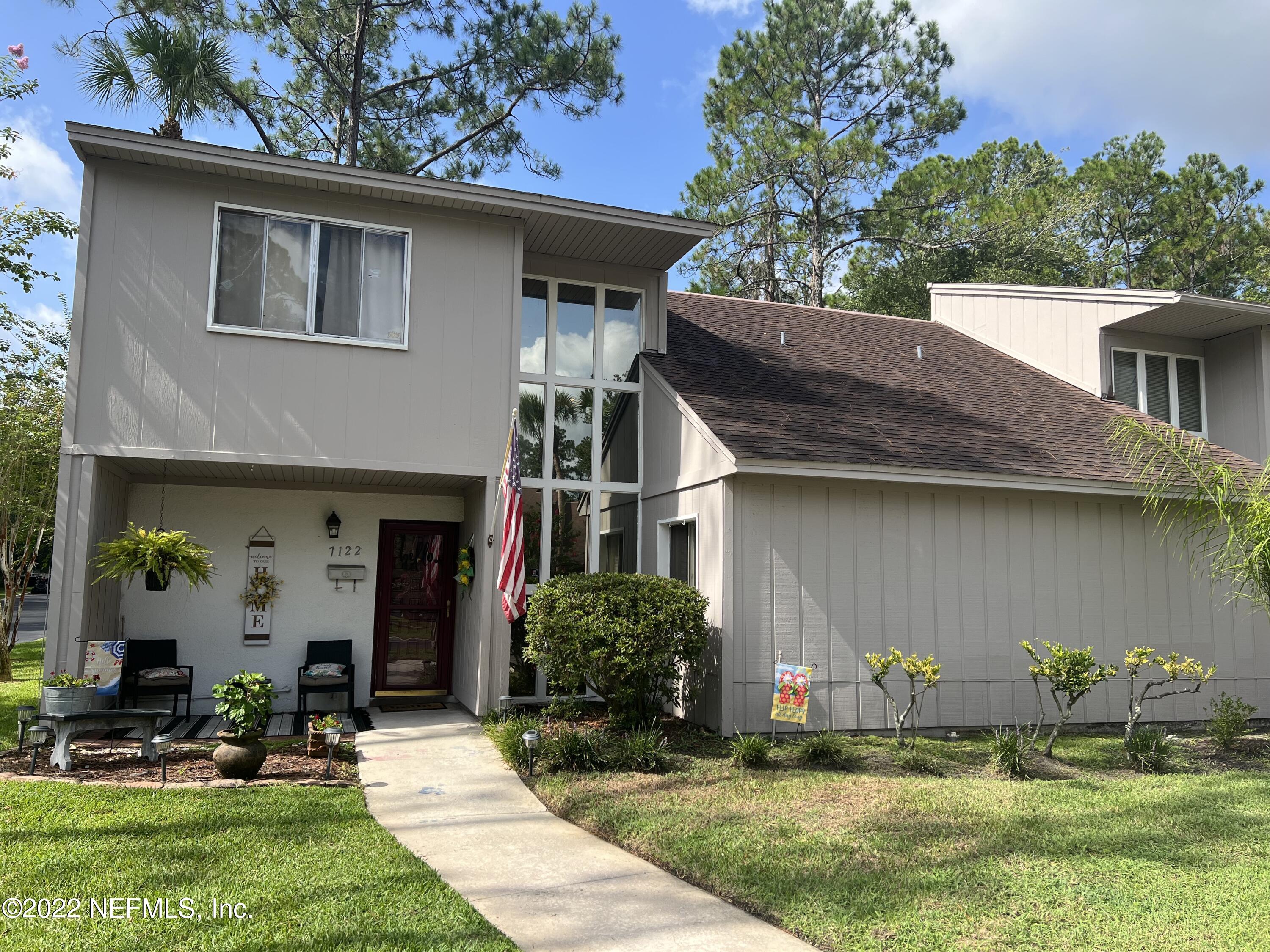 7122 Cypress Cove Road, Unit 47 Jacksonville, FL 32244 - Photo 1 of 24 a front view of house with yard and outdoor seating