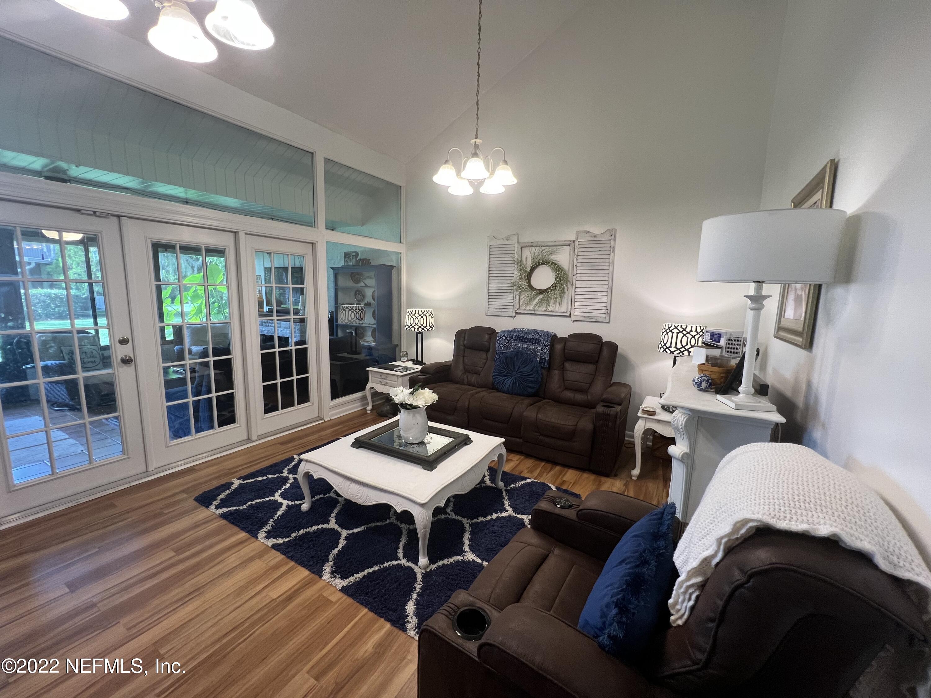 7122 Cypress Cove Road, Unit 47 Jacksonville, FL 32244 - Photo 11 of 24 a living room with furniture and a lamp