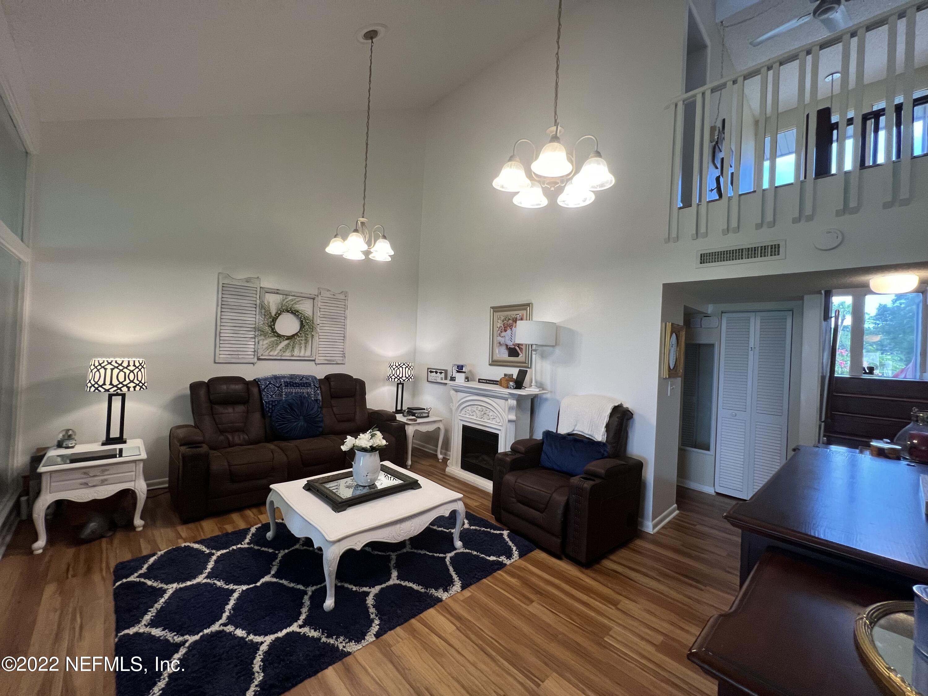 7122 Cypress Cove Road, Unit 47 Jacksonville, FL 32244 - Photo 14 of 24 a living room with furniture a lamp and a window