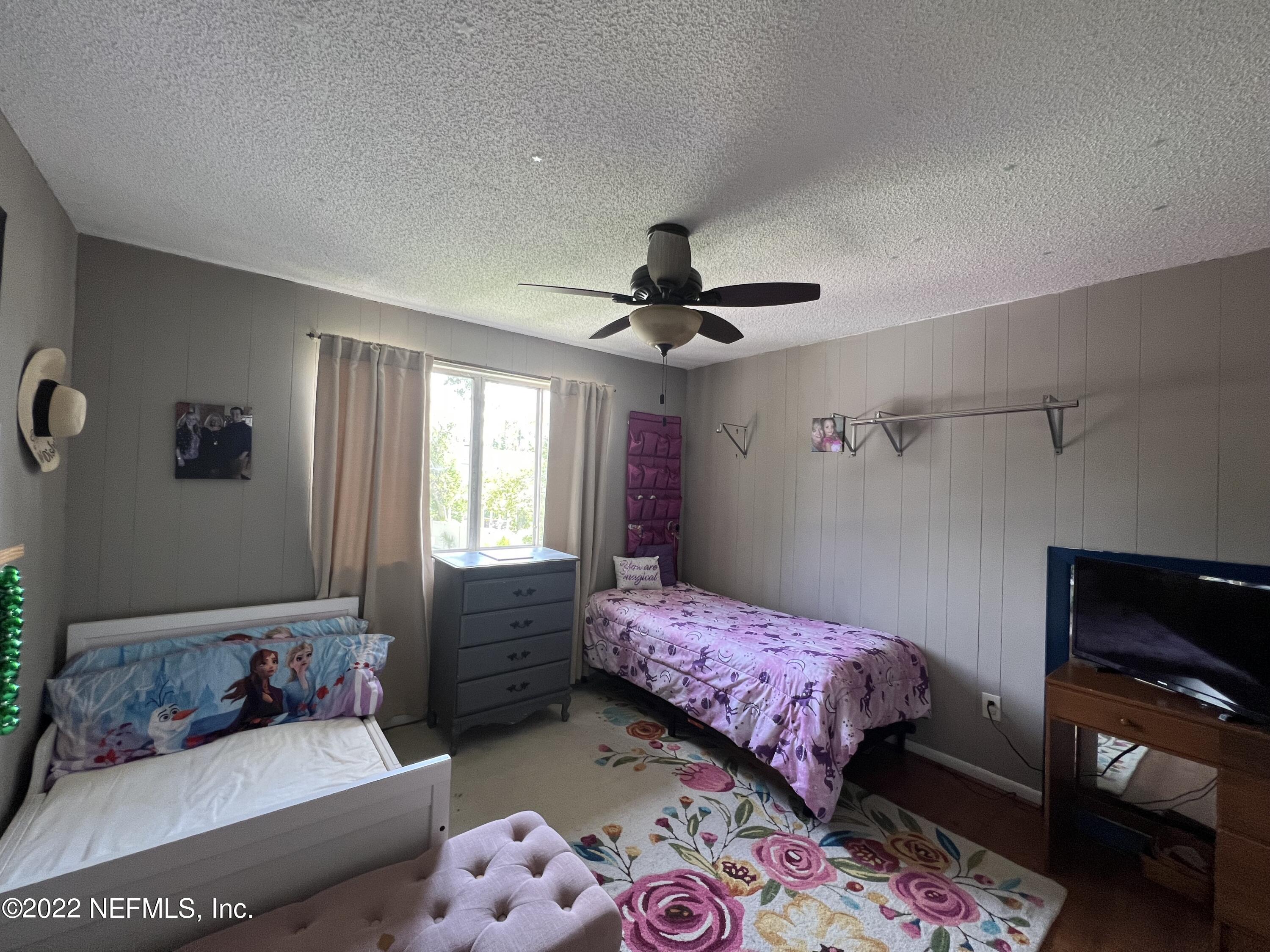 7122 Cypress Cove Road, Unit 47 Jacksonville, FL 32244 - Photo 23 of 24 a bedroom with a bed and a dresser