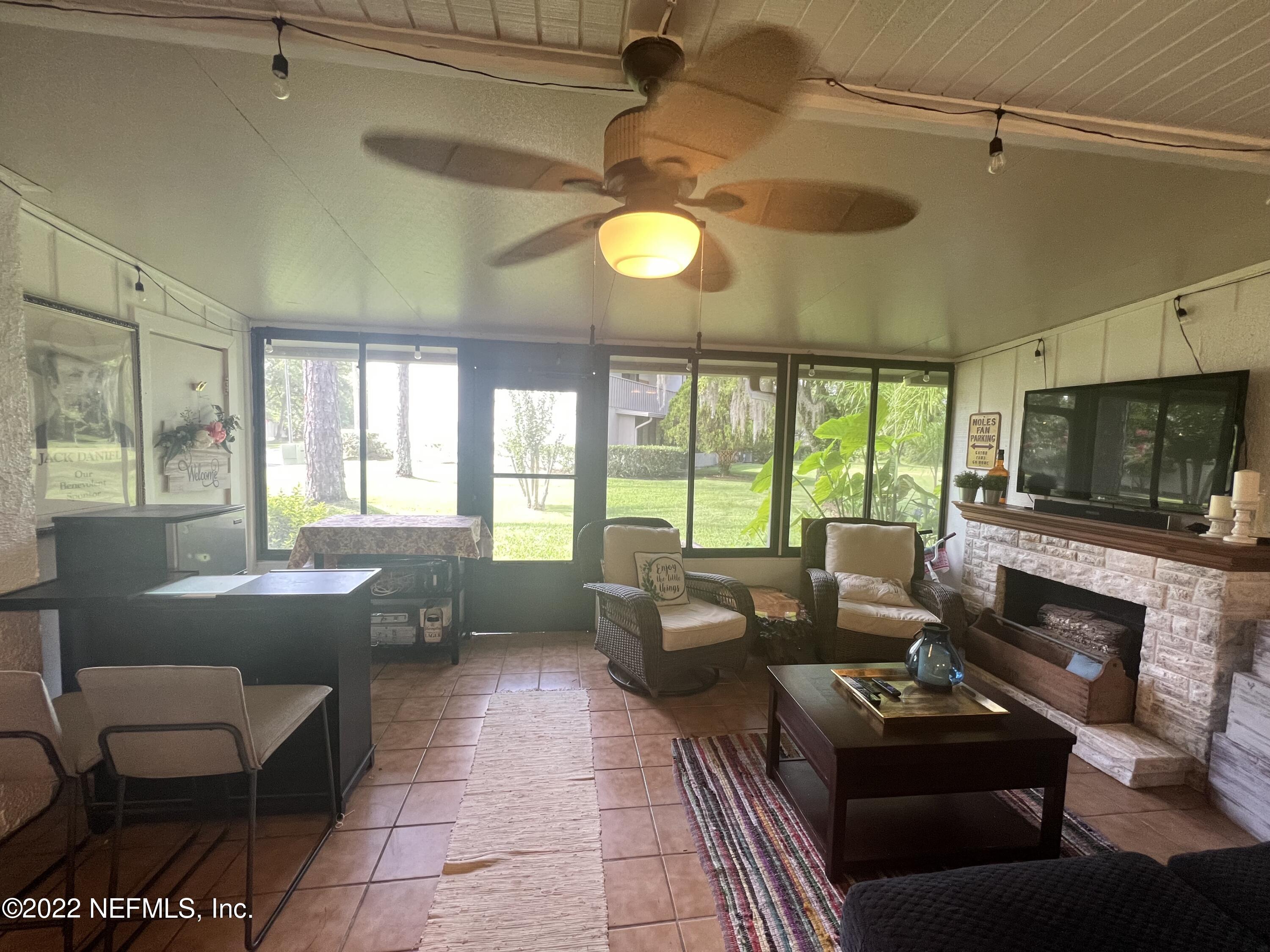 7122 Cypress Cove Road, Unit 47 Jacksonville, FL 32244 - Photo 4 of 24 a living room with furniture and a flat screen tv