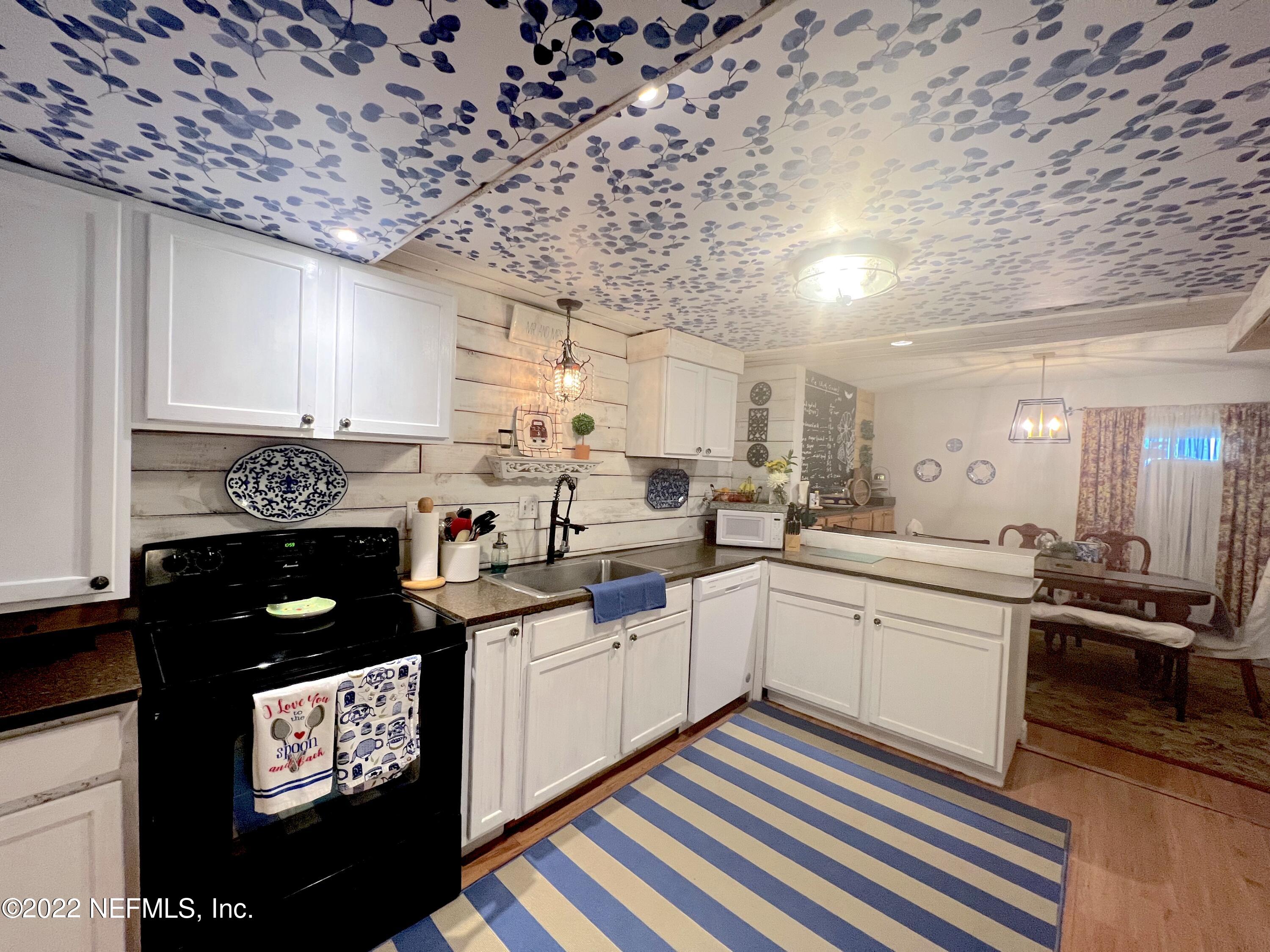 7122 Cypress Cove Road, Unit 47 Jacksonville, FL 32244 - Photo 8 of 24 a kitchen with stainless steel appliances a sink stove and cabinets
