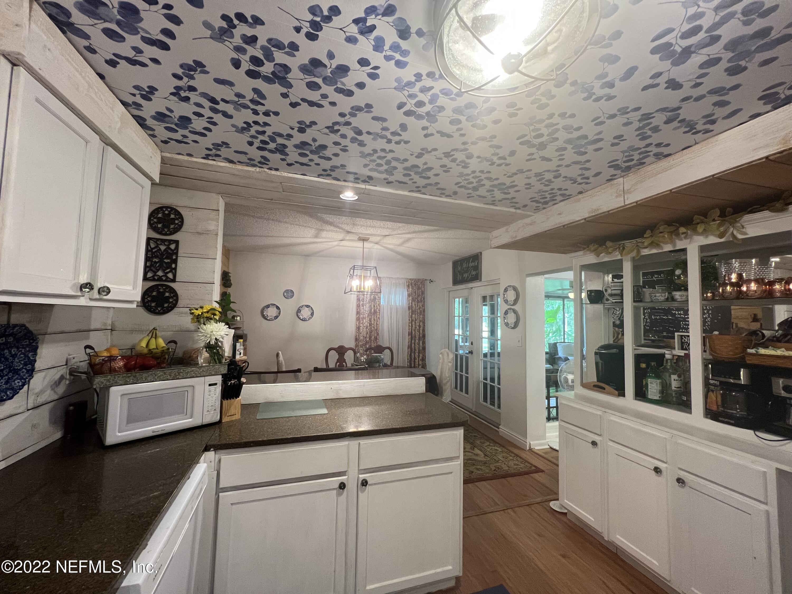 7122 Cypress Cove Road, Unit 47 Jacksonville, FL 32244 - Photo 9 of 24 a large white kitchen with a large window