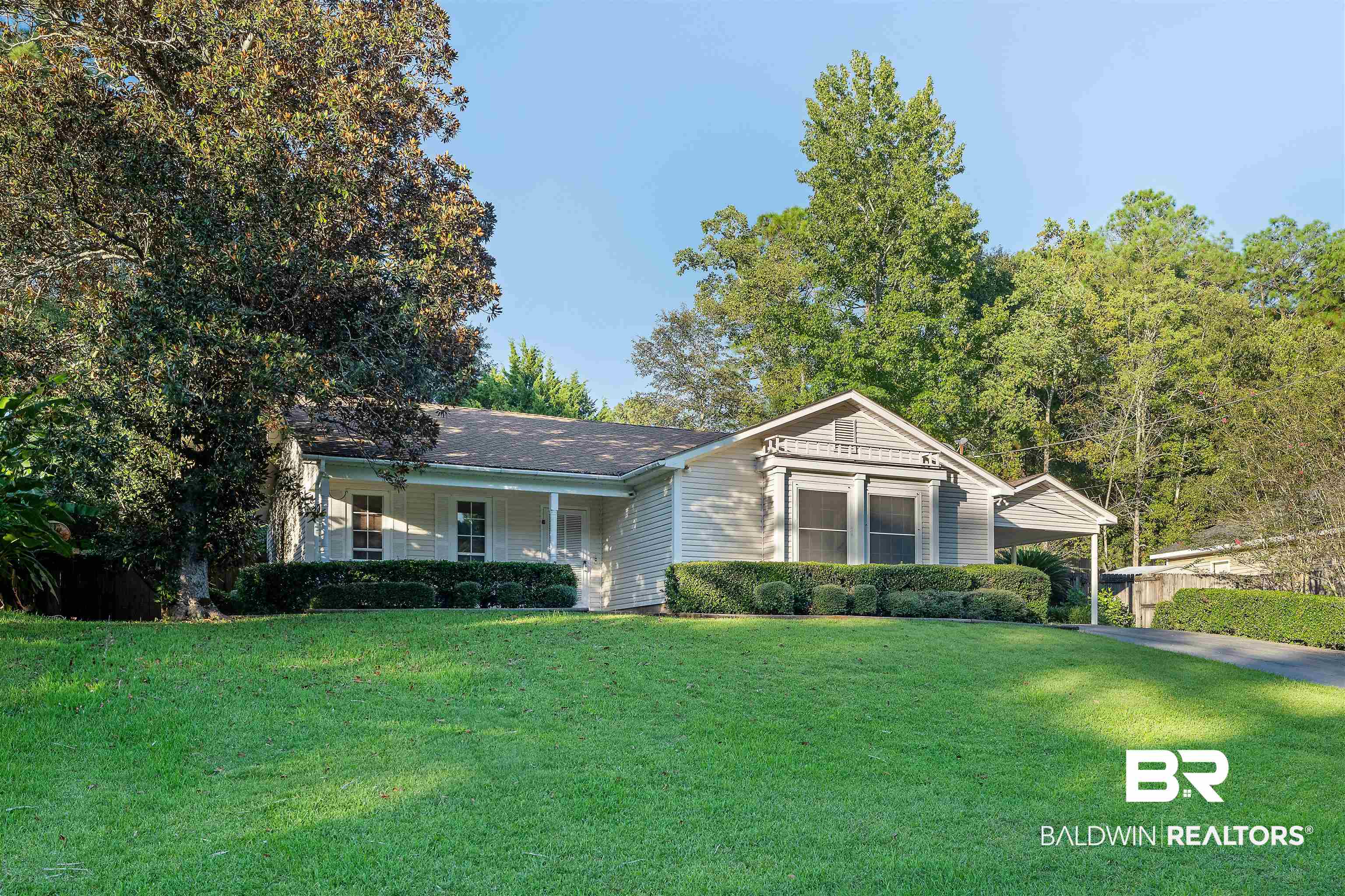 438 Ridgewood Drive Daphne, AL 36526 - Photo 25 of 28 Single story home featuring a carport, a porch, and a front lawn