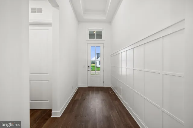 a view of hallway with wooden floor