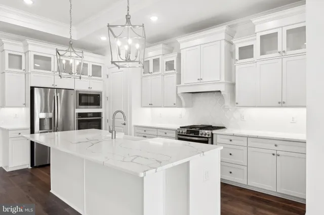 a kitchen with stainless steel appliances granite countertop a sink and cabinets