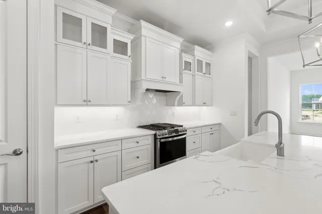 a kitchen with cabinets appliances and a sink