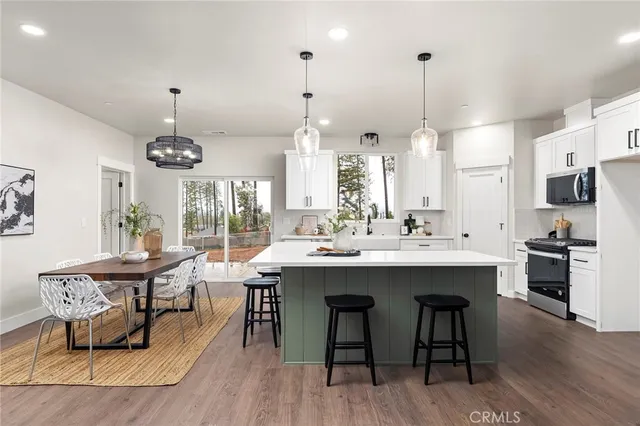 a dining room with furniture a chandelier and wooden floor