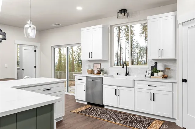 a large white kitchen with a large window