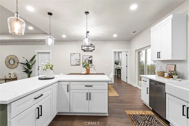 a kitchen with white cabinets and appliances