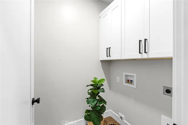 a bathroom with a potted plant on the wall