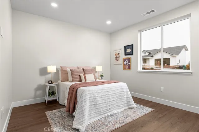 a bedroom with a bed and wooden floor