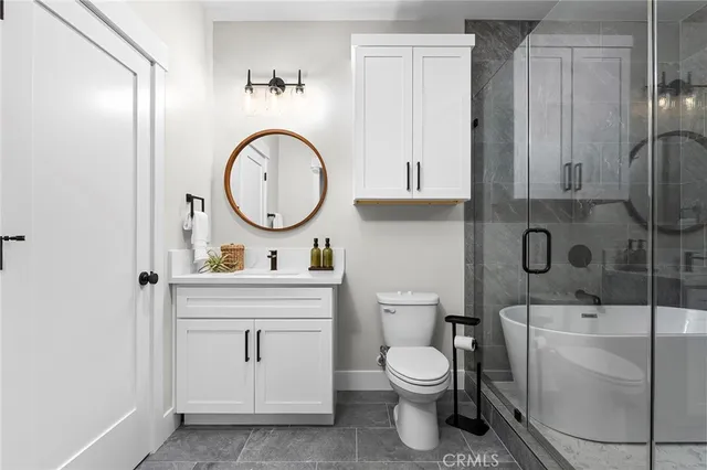 a bathroom with a toilet a sink and a mirror