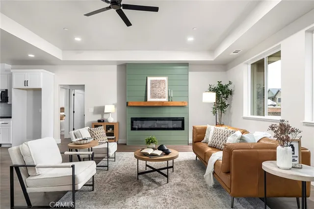 a living room with furniture fireplace and a large window