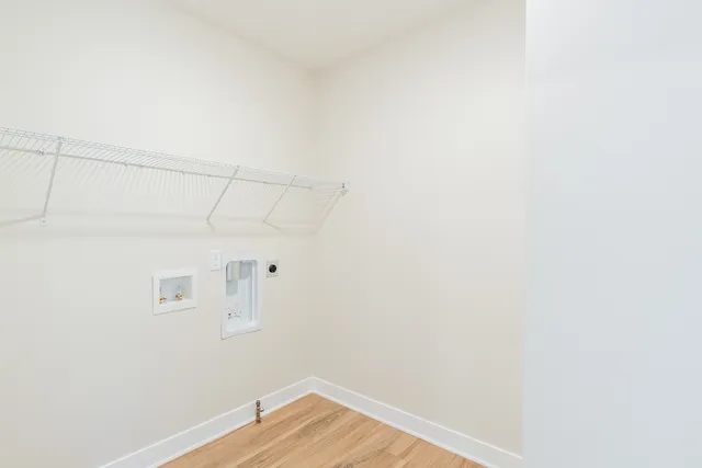 a view of a room with wooden floor