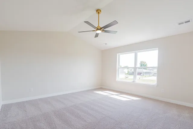 an empty room with a window and a fan