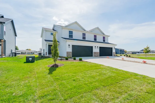 a front view of house with yard and outdoor seating