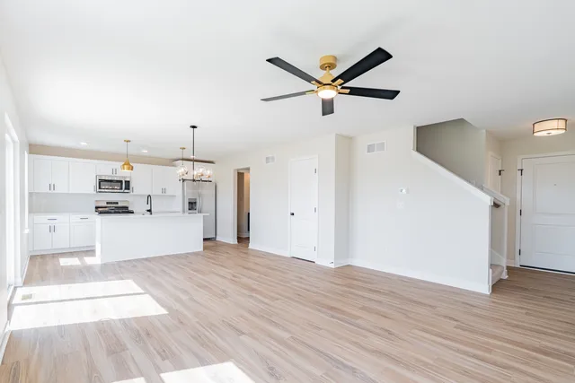 a view of a kitchen with wooden floor and a sink