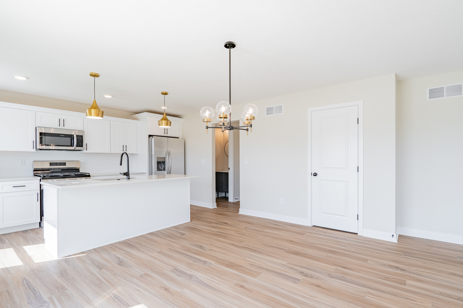 503 Wild Turkey Lane Normal, IL 61761 - Photo 7 of 34 a view of a kitchen with stainless steel appliances granite countertop a refrigerator a stove a microwave and a wooden floor