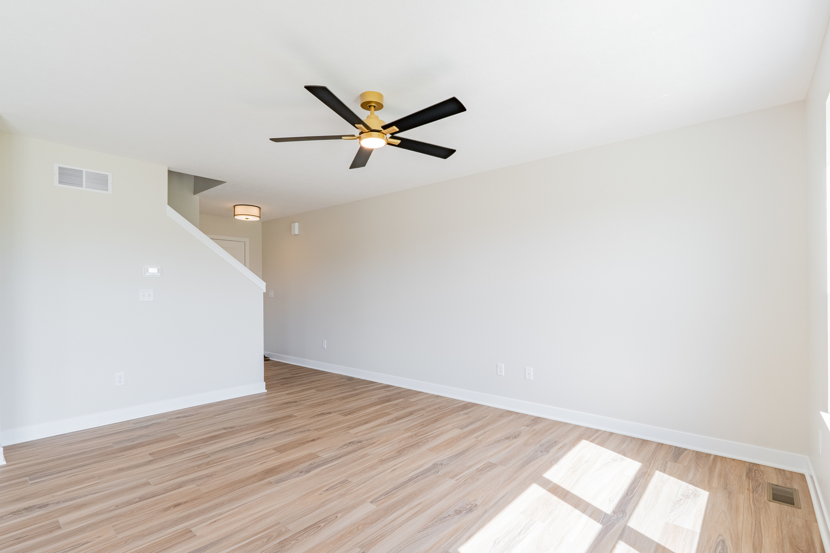 503 Wild Turkey Lane Normal, IL 61761 - Photo 8 of 34 a view of empty room with wooden floor and fan