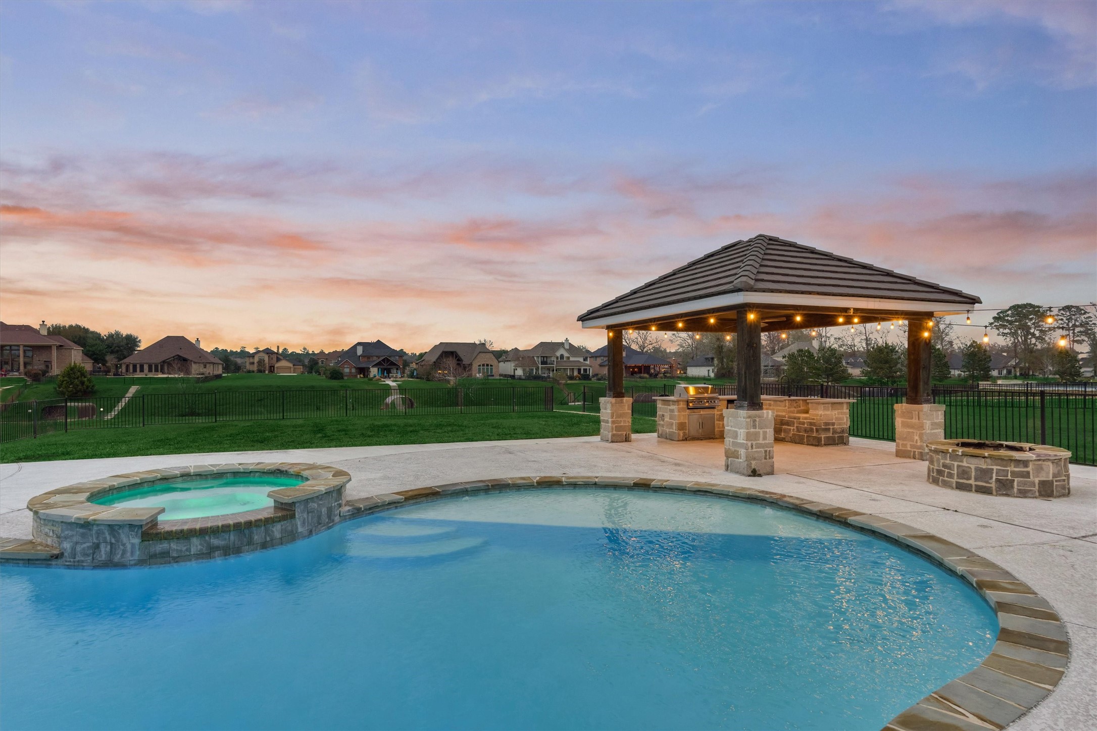 11618 Renaissance Drive Montgomery, TX 77356 - Photo 38 of 49 This backyard retreat features a pool with tanning ledge and an attached hot tub with therapeutic jets- perfect for both entertaining and unwinding after a long day.