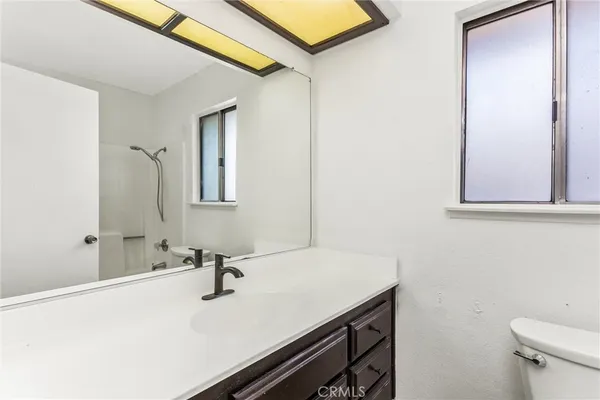 an empty room with a window and a ceiling fan