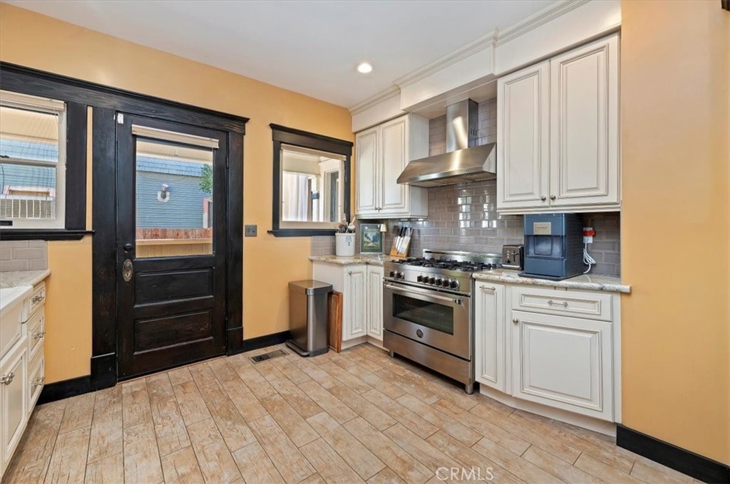 4161 University Riverside, CA 92501 - Photo 26 of 53 a kitchen with granite countertop white cabinets and stainless steel appliances