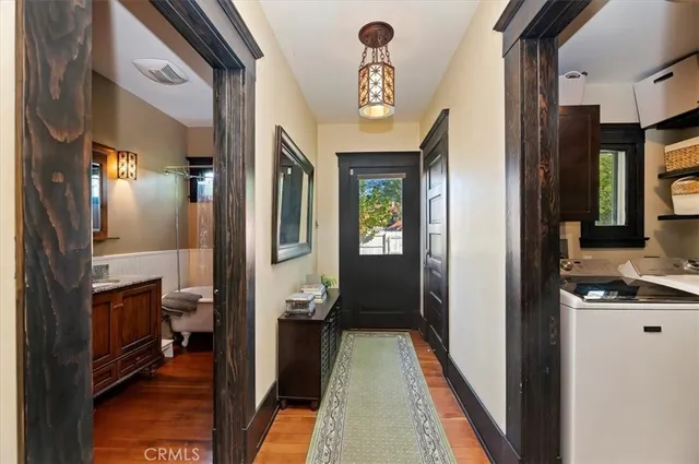a view of a hallway and a livingroom with furniture