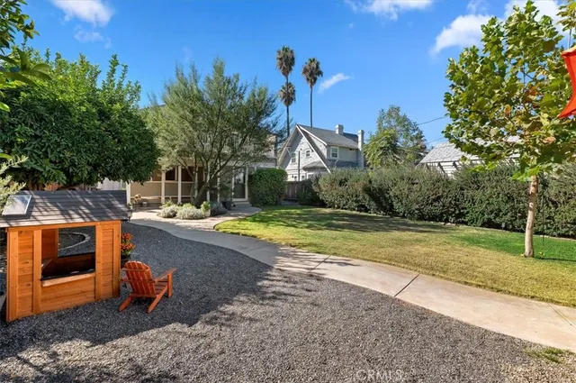 a view of a swimming pool with a yard and plants