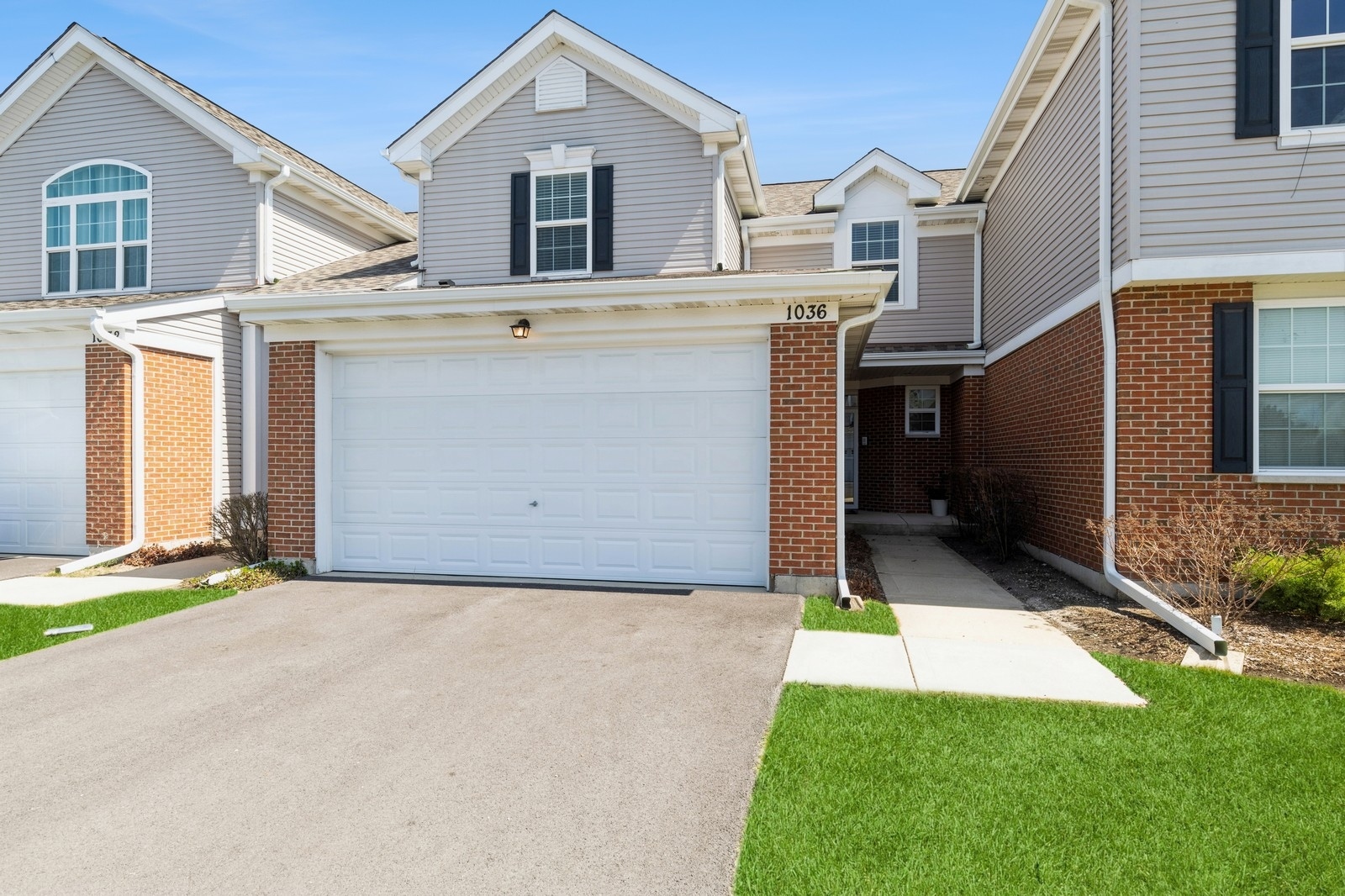 a view of a white house next to a yard