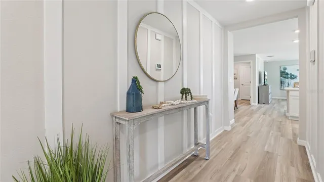 a view of a bathroom with mirror and door