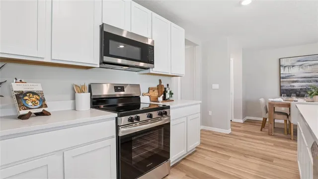 a kitchen with stainless steel appliances a stove a microwave and cabinets
