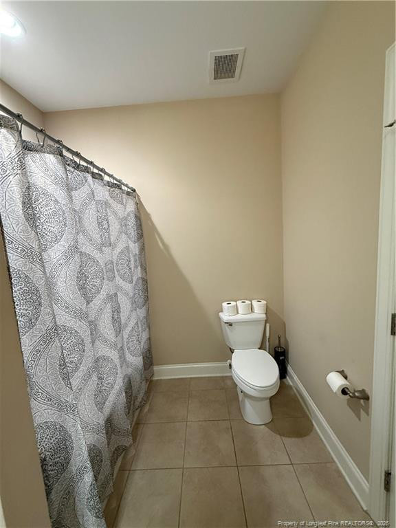 321 Gallery Drive, Unit 203 203 Spring Lake, NC 28390 - Photo 5 of 25 a bathroom with a toilet and a shower curtain
