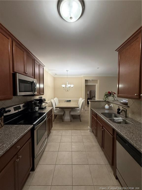 321 Gallery Drive, Unit 203 203 Spring Lake, NC 28390 - Photo 9 of 25 a kitchen with stainless steel appliances granite countertop a sink stove and refrigerator