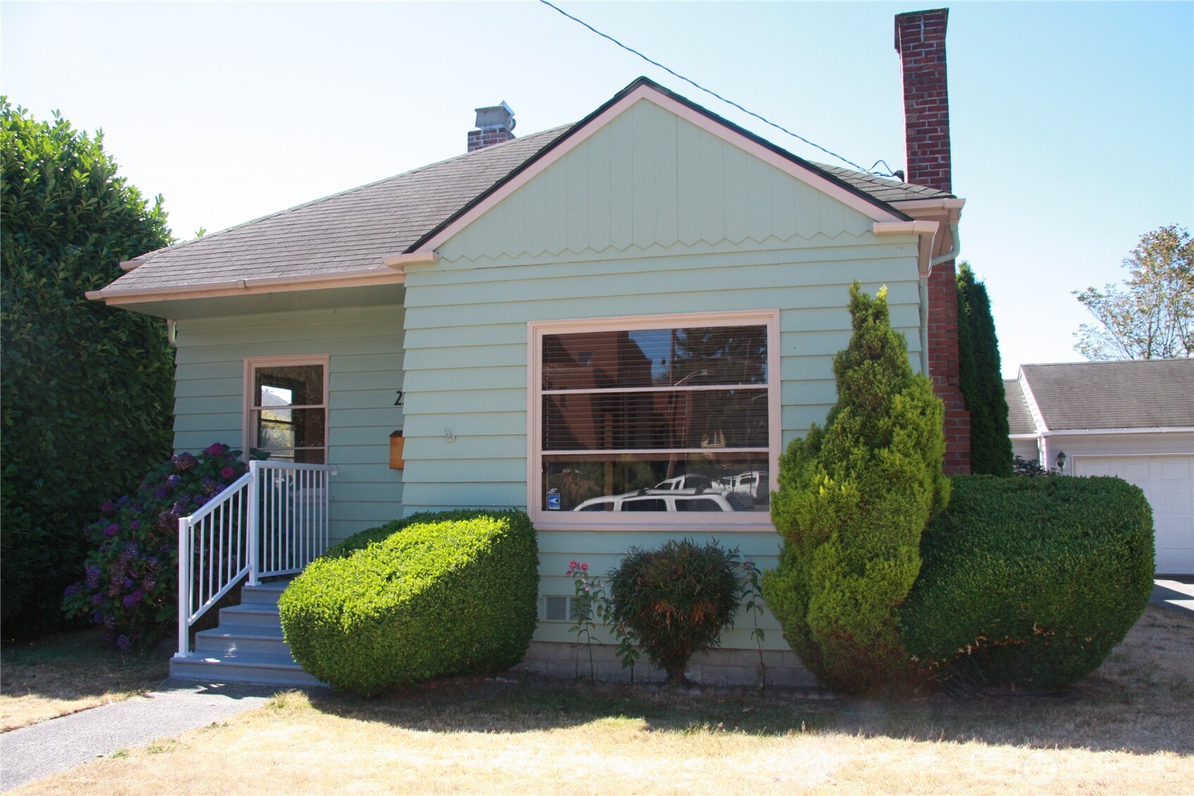 2213 Northwest 65th Street Seattle, WA 98117 - Photo 1 of 11 a front view of a house with garden