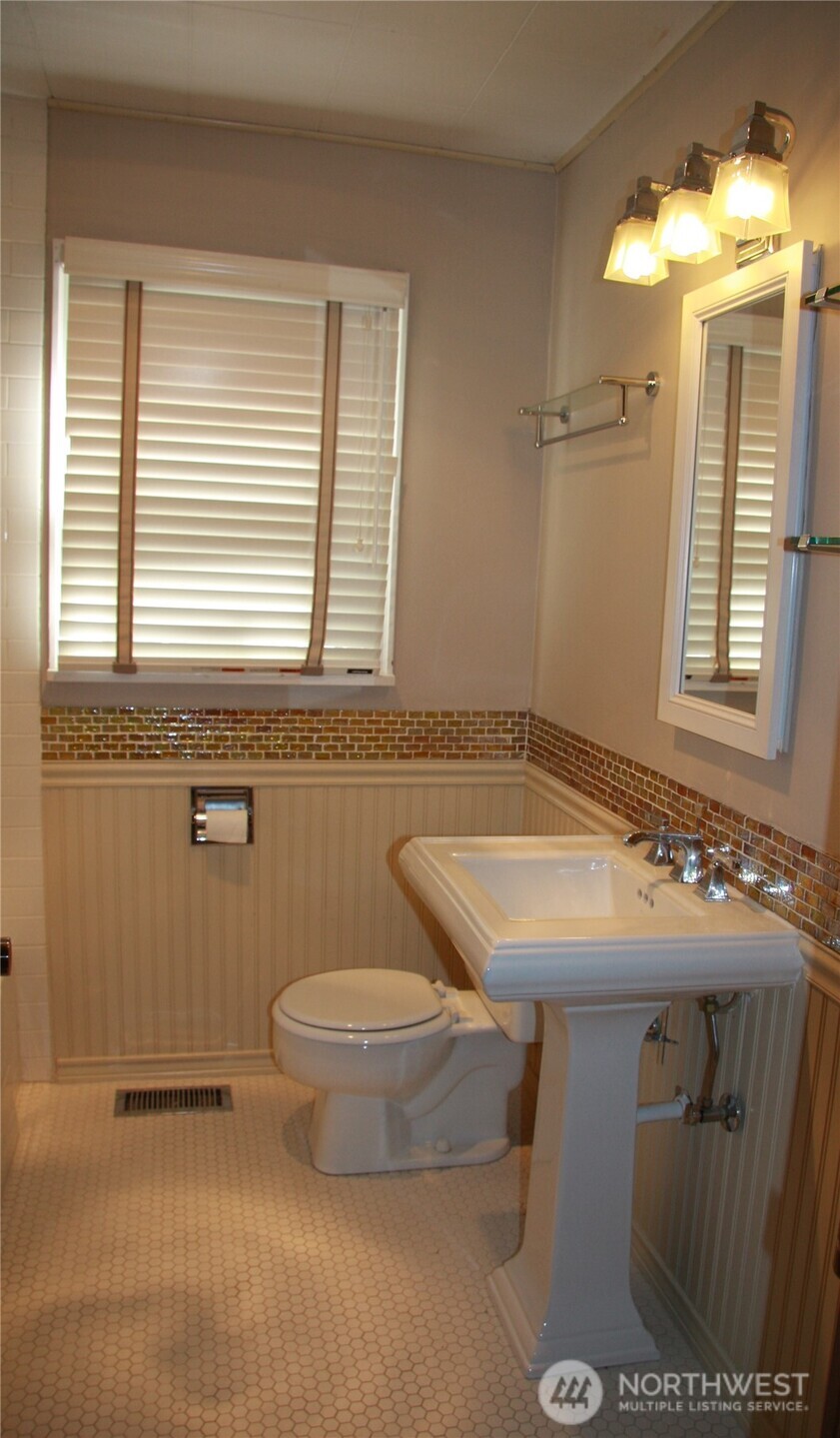 2213 Northwest 65th Street Seattle, WA 98117 - Photo 8 of 11 a bathroom with a sink and a toilet