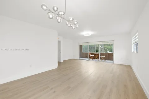 a view of a livingroom with furniture window and wooden floor
