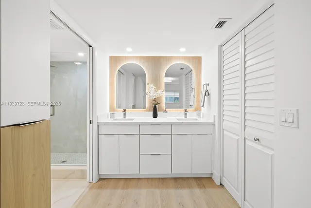 a bathroom with a double vanity sink and mirror