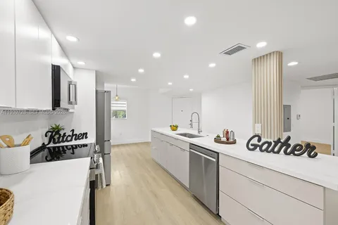 a kitchen with a sink stove and cabinets