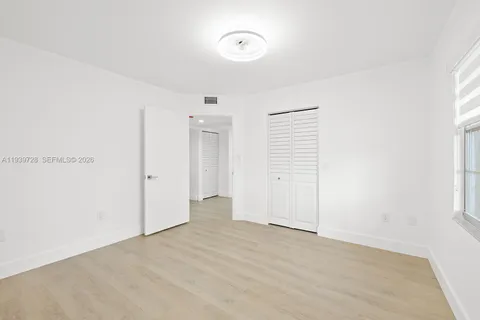 a view of a room with an empty space and a window