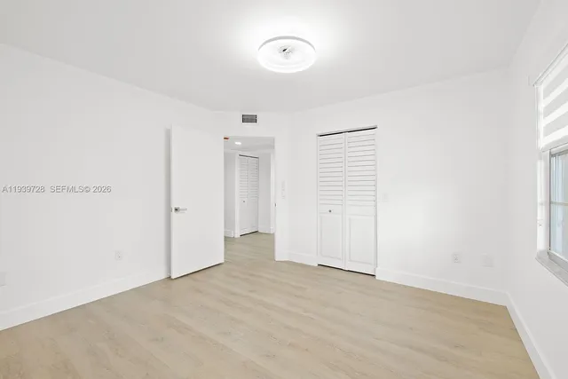 a view of a room with an empty space and a window