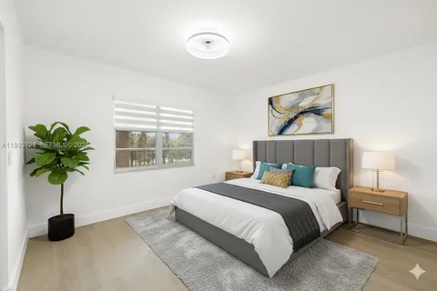 a bedroom with a bed potted plant and a window