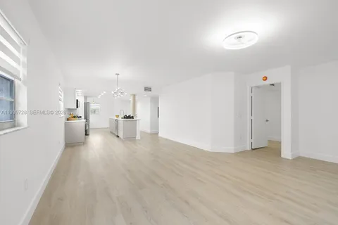 a view of a kitchen with a refrigerator and a window