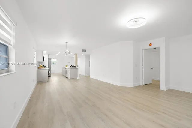 a view of a kitchen with a refrigerator and a window